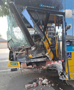 Man hospitalised after car reverses into bus
