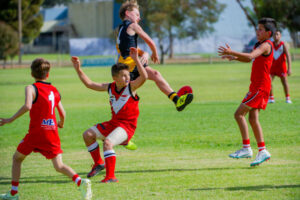 Footy team caps give kids a fair go