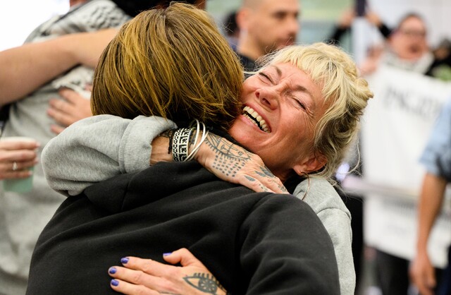 Aussie activists arrive home to applause and chants